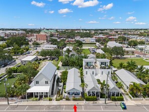 A residential area with single-story houses, a parking lot, and a clear view of the surrounding neighborhood.