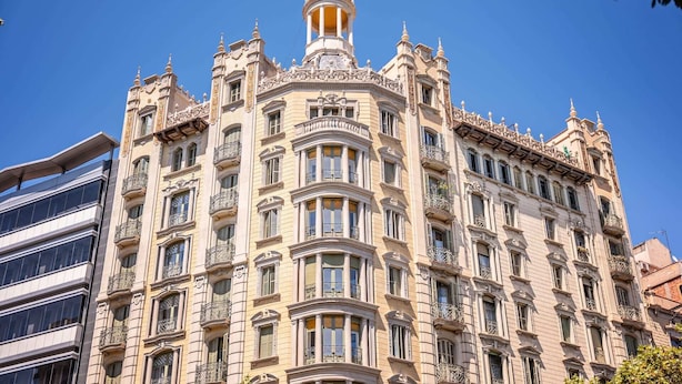 A historic building with ornate architectural details, including a dome and multiple balconies. - Sweett | The Diagonal Suites III (Barcelona)