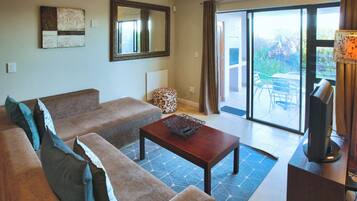Comfort Apartment, Garden View | Living area | Flat-screen TV