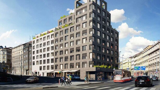Een meerlaags gebouw met een modern architectonisch ontwerp, met een combinatie van balkons en grote ramen.