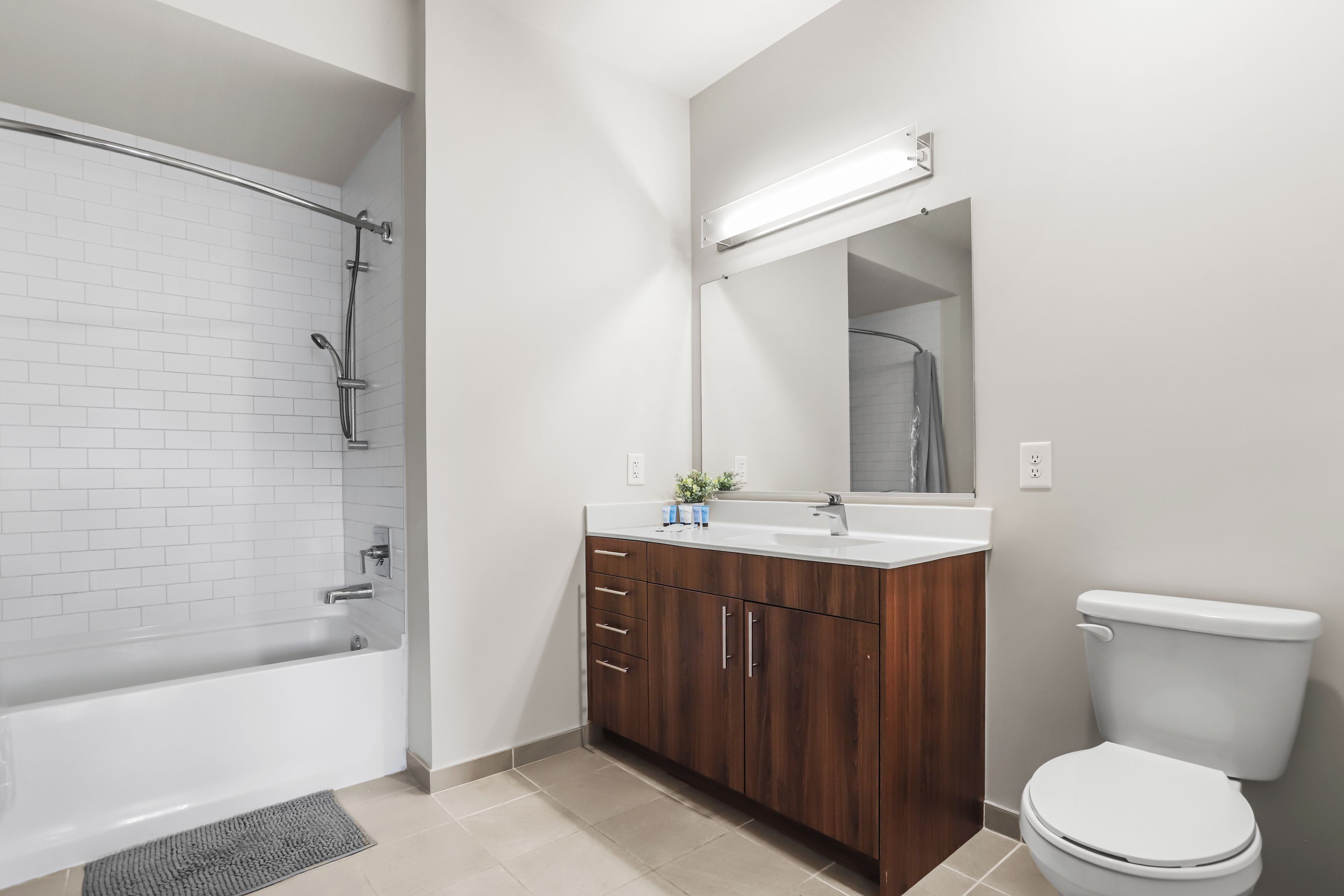 A bathroom with a bathtub, a shower, a sink, and a toilet.