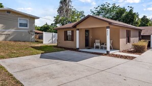 A single-story mobile home with a front porch, two chairs, and a mailbox. - Spotless Escape in the City`s Core 837 (Clermont)