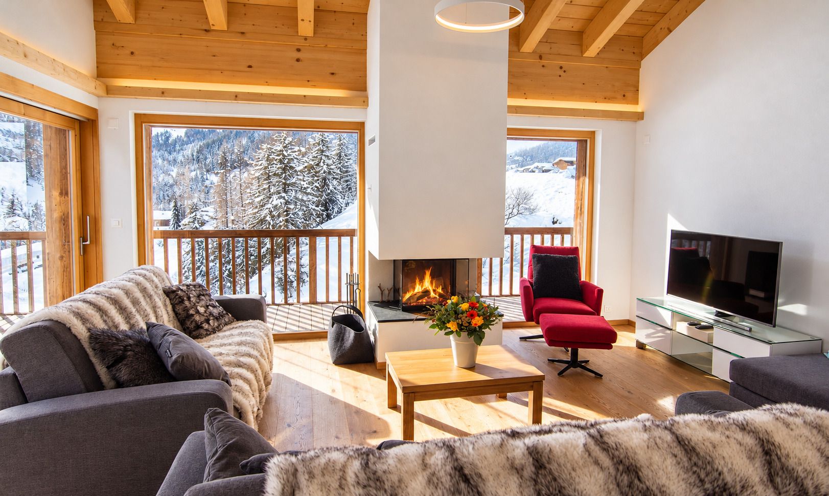 A cozy living room with a fireplace, a television, and a sofa.