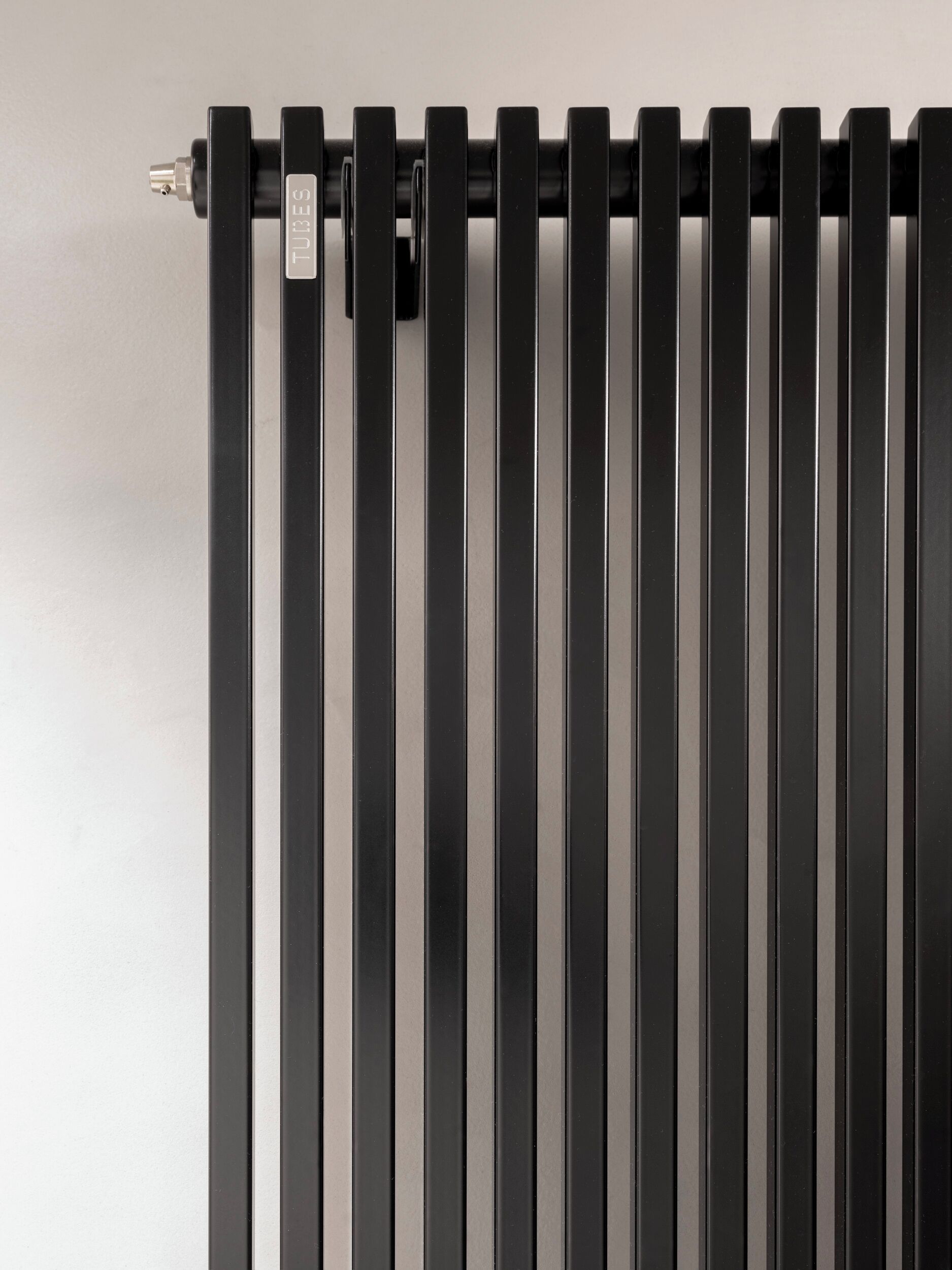 A black radiator with a visible brand label.