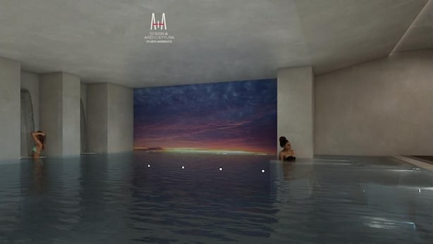 Een ruim overdekt zwembad met een zonsondergangmuur aan de achtergrond, een transparant dak en een minimalistisch ontwerp.