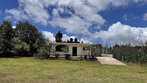 A single-story house with a large front yard, a garage, and a small garden area. - Casa rodeada de naturaleza  (Zacatlán)