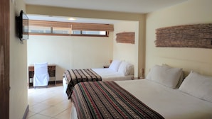 A hotel room with two beds, a TV mounted on the wall, and a window with blinds. - Hostal Geosol (Antofagasta)