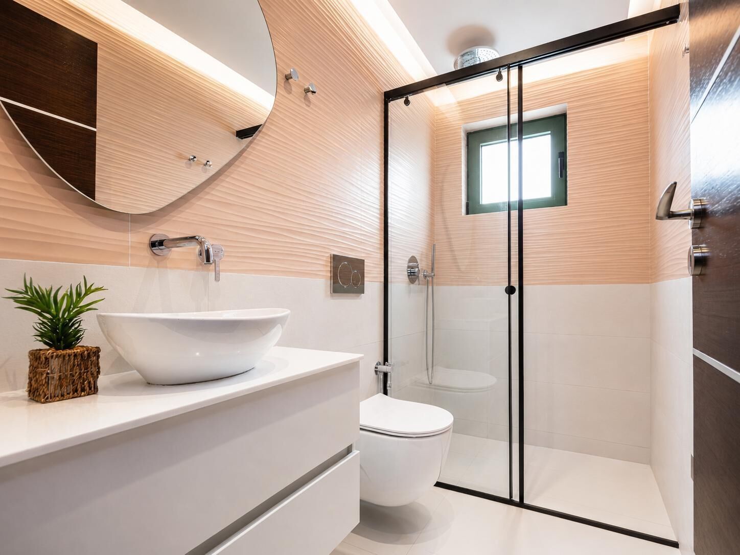 A modern bathroom with a large white sink, a toilet, and a glass-enclosed shower.