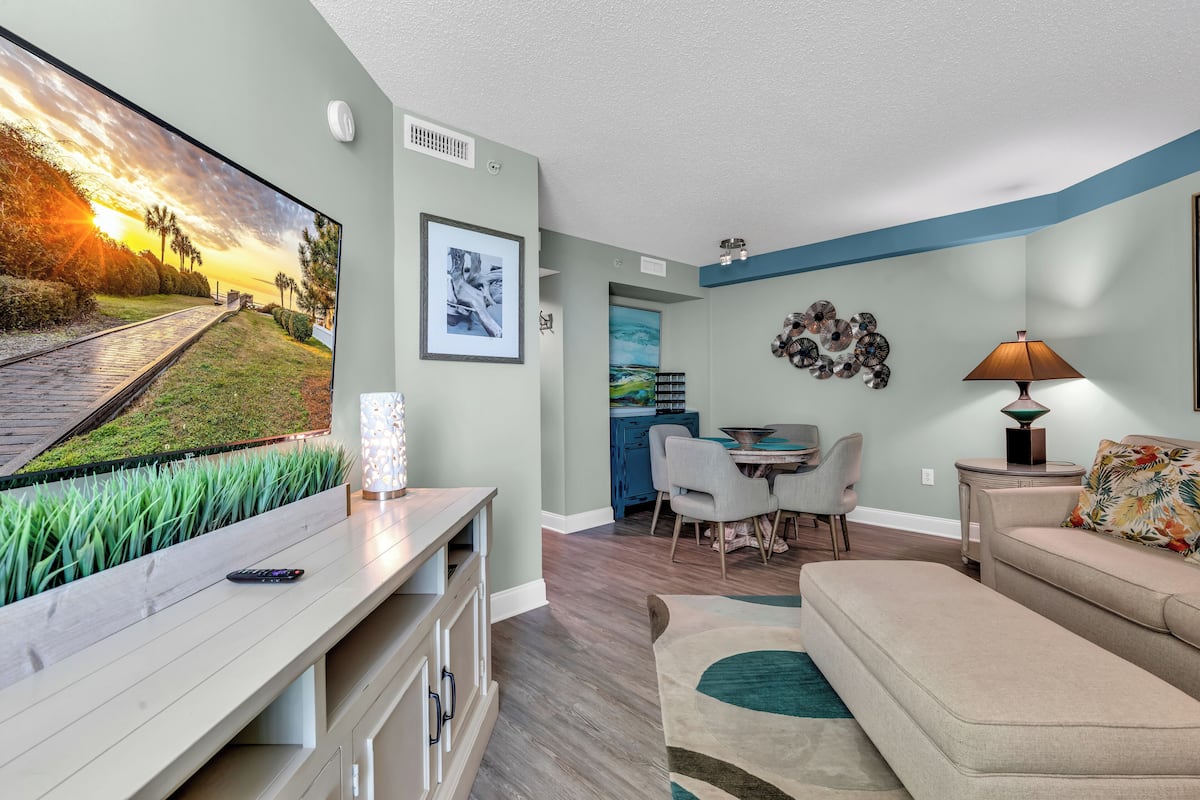 Signature Condo, 1 King Bed with Sofa bed, Kitchen, Partial Ocean View | Living area | TV