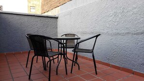 A small outdoor patio with a round table and two chairs. - 2 bedroom apartment in the best area of Laureles. A/C. (Medellín)