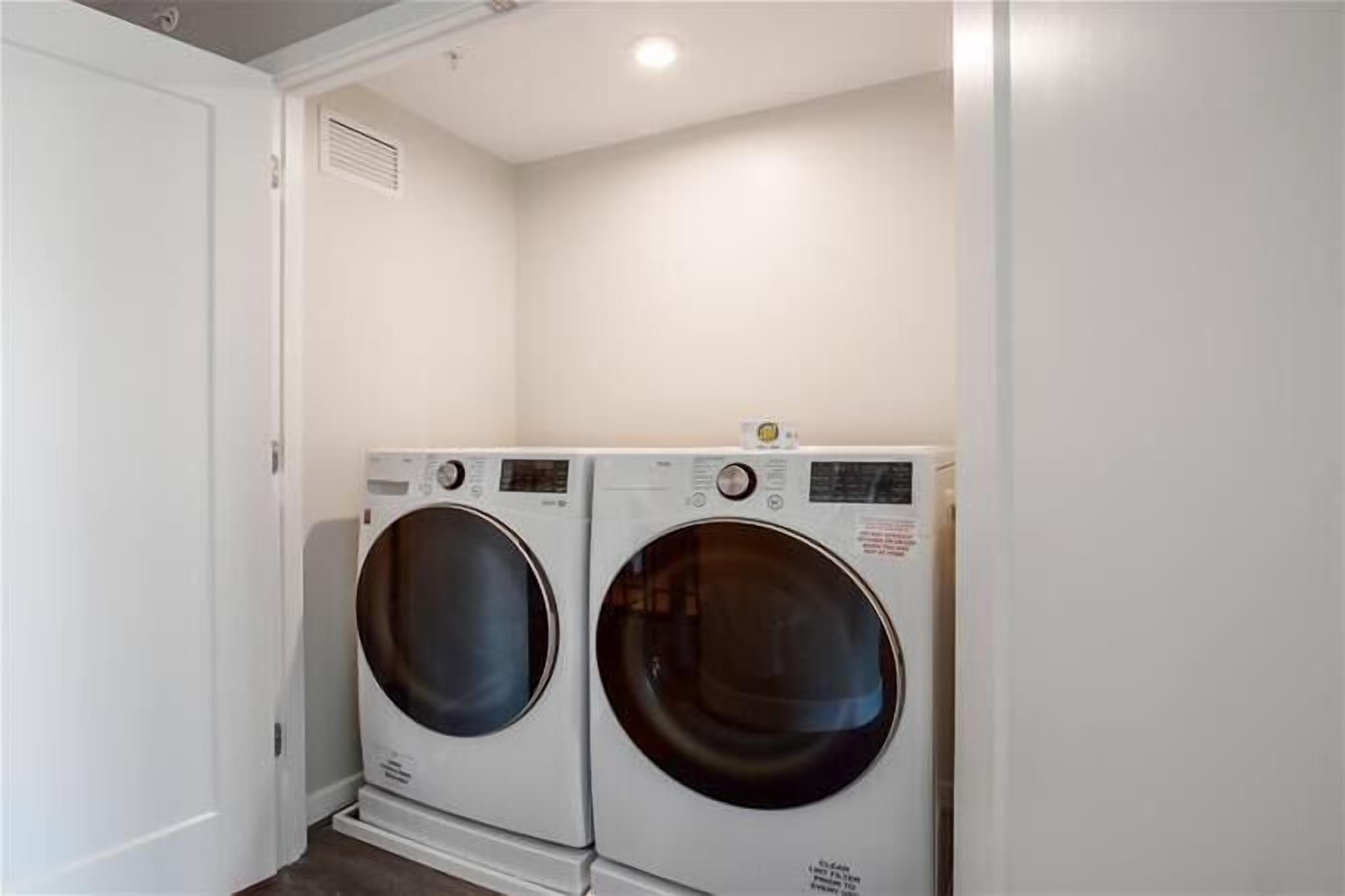 A laundry room with two stacked front-loading washing machines.