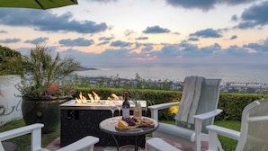 A patio with a fire feature, outdoor seating, and a scenic view of the ocean. - Cove Watch by Avantstay A+ Views w/ Private Pool (La Jolla)