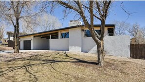 A modern two-story house with a flat roof, large windows, and a covered patio area. - Hidden Jewel for the Family, Near the Broadmoor (Colorado Springs)