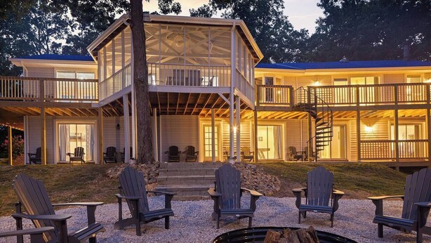 A two-story building with a covered deck and outdoor seating area. - Lakefront Retreat w/Pvt Dock, Game Room, Hot Tub (Murray)