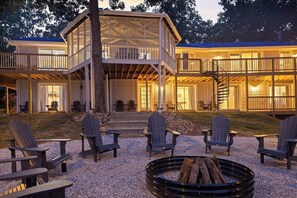 A two-story building with a covered deck and outdoor seating area.