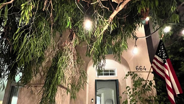 A building entrance with a door marked "664," a potted plant, and an American flag. - OCEANSIDE BEACH HOUSE~Dreamy Palm Tree Lined Street~5 MIN WALK to EVERYTHING!  (Oceanside)