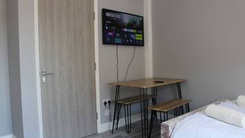 Classic Quadruple Room | Living area | TV