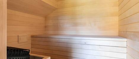 A sauna with wooden walls and a bench.