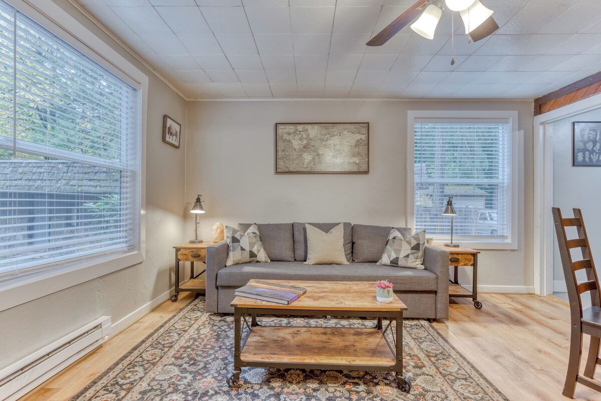 A living room with a sofa, coffee table, and two side tables.