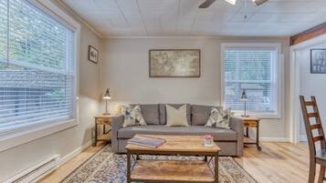 A living room with a sofa, coffee table, and two side tables.