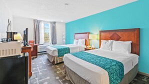A hotel room with two beds, a desk, a chair, a TV, and a window with curtains. - Moonlight Inn Hotel O Hattiesburg, MS (Hattiesburg)