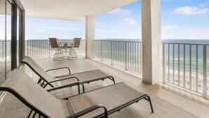 A balcony with a view of the ocean, equipped with metal chairs and a table. - Windward Pointe 1401-large Balcony Best Views (Orange Beach)