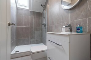 Shower, hair dryer, towels, toilet paper