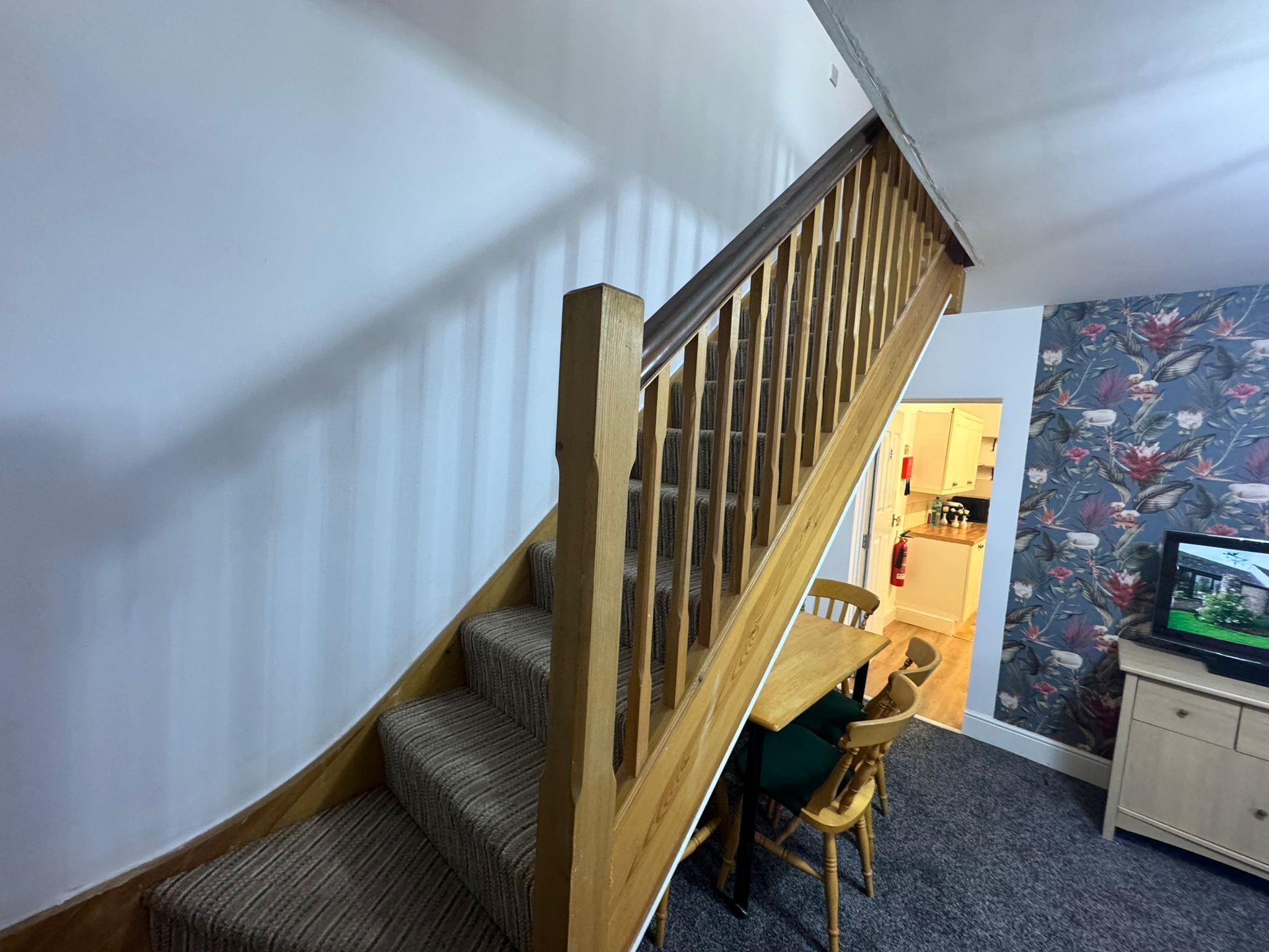 A staircase with wooden railings leading to a landing.