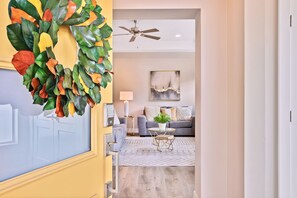 A modern living room with a grey sofa, a round coffee table, and a ceiling fan. - 2 Adjacent Modern Homes • Sleep 16 • Near Top Shopping, Dining & Entertainment (Meridian)
