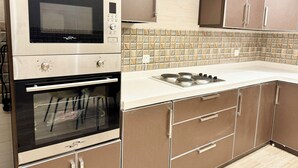 A kitchen with a built-in oven, microwave, and gas stove.