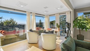A spacious balcony with a dining area, cushioned seating, and a potted plant. - DREAM HOUSE IN PASADENA (Pasadena)