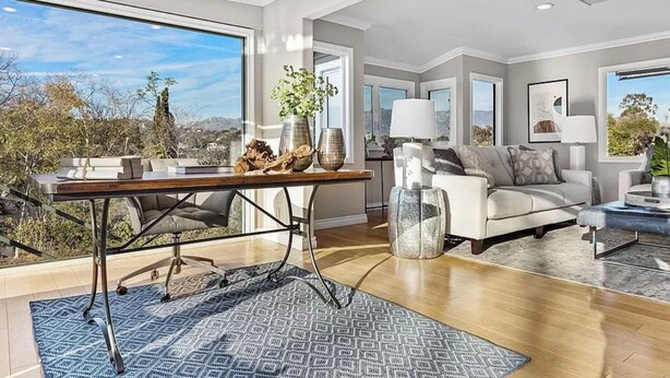 A spacious living room with a large window, a wooden coffee table, a sofa, and a dining area with a table and chairs. - DREAM HOUSE IN PASADENA (Pasadena)