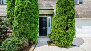 A house with a black door, number 433, and a garage door.