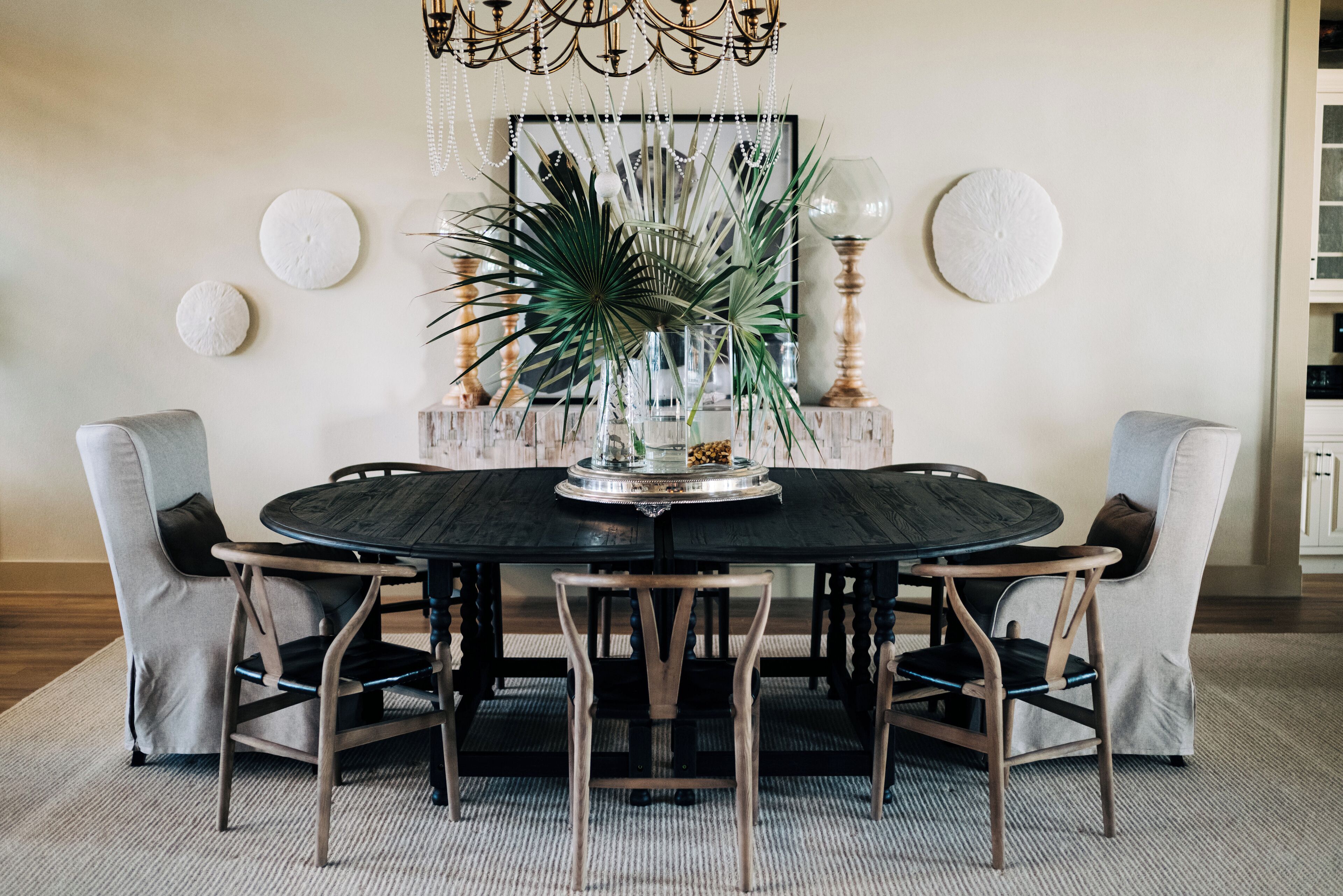 A round dining table with a central decorative piece, surrounded by four chairs.