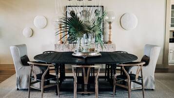 A round dining table with a central decorative piece, surrounded by four chairs.