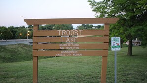 A wooden sign for Troost Lake with text indicating it is managed by the Board of Parks and Recreation, Kansas City, Missouri. - 4bed studio basement! 5min->downtownKC (Kansas City)