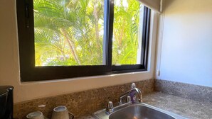A kitchen with a window, sink, and countertop. - Posada Don Esteban by PartnerHost (Loreto)