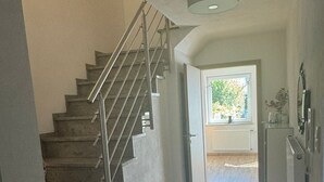 A staircase with metal railings leading to a landing.