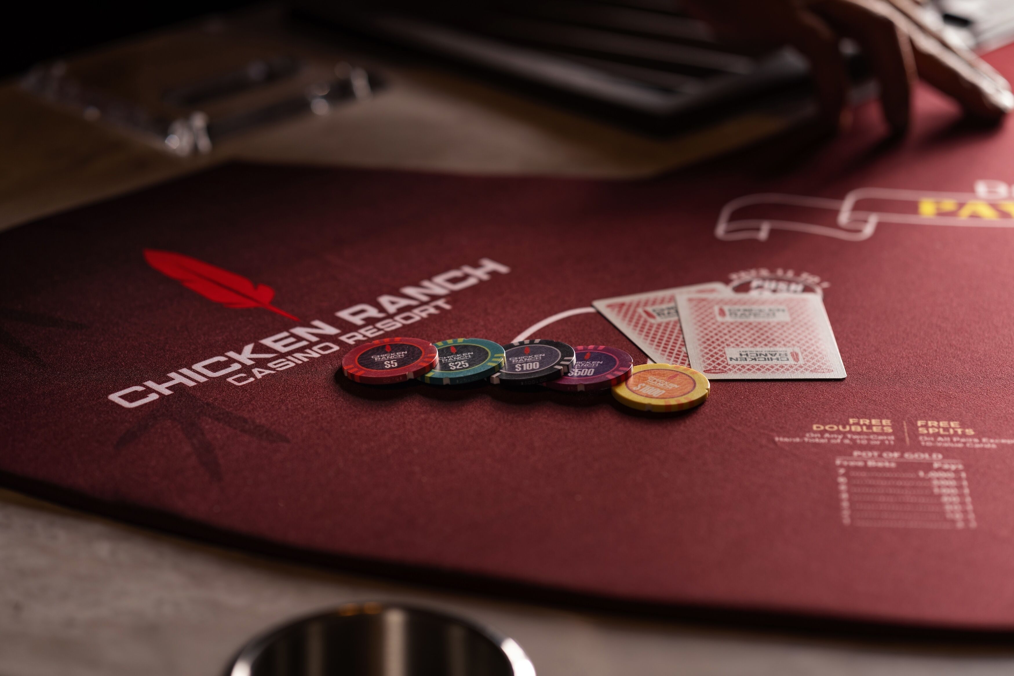 A red table with a logo for Chicken Ranch Casino Resort, poker chips, and a menu.