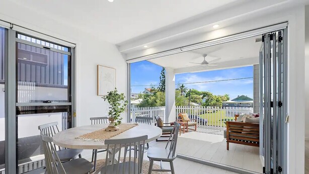 A modern kitchen with a built-in oven and a large window. - Oceanviews on Pearl (Kingscliff)