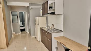 Apartment | Private kitchen | Full-size fridge, microwave, stovetop, cookware/dishes/utensils