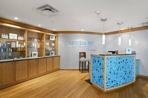 A reception area with a tiled counter, wooden cabinets, and a sign reading 'sandava spa'.