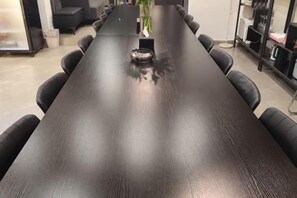 A long, dark wooden conference table with chairs around it, in a room with a modern design. - West Lafayette seaview Inn (Shenzhen)