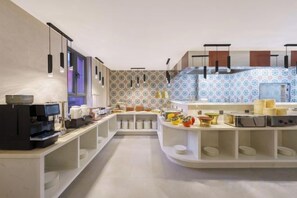 A modern kitchen with built-in appliances, a central island, and a patterned backsplash. - Benison VII Boutique Hotel (Urumqi)