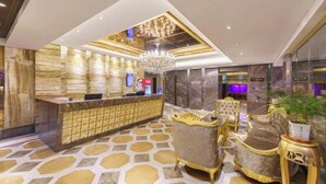 A lobby with a reception desk, a chandelier, and ornate chairs. - Benison VII Boutique Hotel (Urumqi)