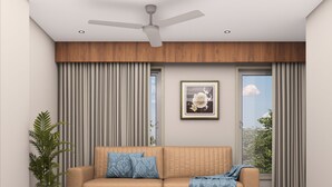Una sala de estar moderna con un sofá, un ventilador de techo, un cuadro enmarcado y una planta en maceta.