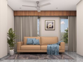 Una sala de estar moderna con un sofá, un ventilador de techo, un cuadro enmarcado y una planta en maceta.