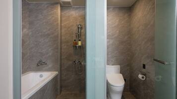 Un bagno moderno con doccia vetro, vasca da bagno e toilette.