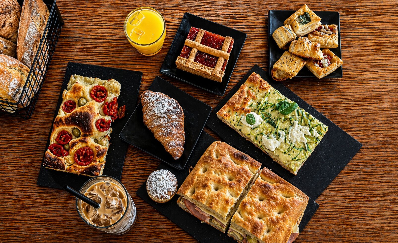 A variety of pastries and desserts on a wooden table.