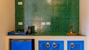 A kitchen with green mosaic tiles, a blue refrigerator, and blue cabinets with gold handles. - Balcony Superior with communal pool Ma8 (Ciudad de Panamá)